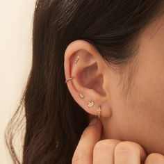 a close up of a person's ear with two piercings