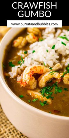 a white bowl filled with shrimp gumbo next to rice and garnished with parsley