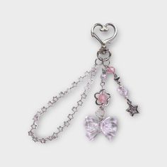 a keychain with charms attached to it's sides and two hearts on each side