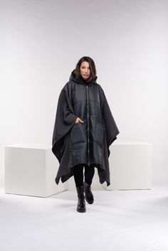 "Stay warm while staying fashionable with this unique puffer jacket poncho with oversized pockets and zipper closure, and a large cozy hood. This maxi quilted coat has a street vibe and is unisex for all body types. You can wear it in different ways, go all the way as a poncho, or halfway through. Made from two fabrics - puffer quilted fabric and wool knitted fabric, and while the textiles are different, there is a relationship in the shapes. A good jacket or coat can really make an outfit. It's the finishing touch before walking out the door. ◼️FIT This puffer jacket is a one-size design. It is roomy and oversized and it fits all our sizes from XS to 4XL. ◼The model in the picture is wearing the color Dark Gray. ◼️FABRIC ◾polyester quilted fabric with viscose lining, knitted acrylic wool Oversized Urban Puffer Jacket With Detachable Hood, Oversized Techwear Puffer Jacket For Fall, Oversized Techwear Outerwear With Zipper, Oversized Techwear Outerwear With Zipper Closure, Urban Oversized Puffer Jacket For Outdoor, Oversized Techwear Puffer Jacket, Oversized Techwear Puffer Jacket For Outdoor, Oversized Hooded Parka For Outdoor, Oversized Outerwear With Zipper For Outdoor