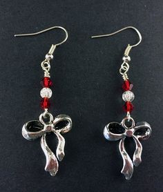 "Antique Silver Ribbon and Bow Earrings with Red and Clear Swarovski Crystals, Festive Holiday Jewelry, Simple Silver and Red Ribbon Earrings Special Holiday Earrings, perfect for gifts and seasonal jewelry Silver Tone Zinc metal alloy(Cadmium Free) Earring Size: ~1.75\" x 3/4\" All Aspen Tree Jewelry is made and stored in a smoke free environment and comes gift wrapped." Red Jewelry For Holiday Jewelry Making, Red Earrings For Valentine's Day Holiday, Holiday Red Nickel-free Jewelry, Red Earrings For Christmas Gift, Holiday Red Adjustable Jewelry, Red Jewelry For Holiday Party, Valentine's Day Party Jewelry With Red Bow, Red Dangle Holiday Jewelry, Red Christmas Jewelry Gift