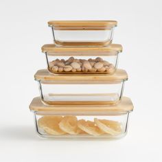 three glass containers with food in them stacked on top of each other and one container filled with chips