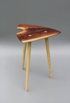 a wooden table with two legs and a piece of wood sticking out of the top