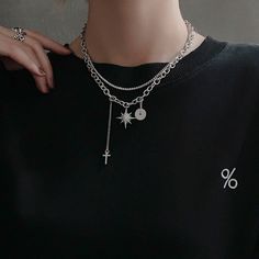 Unisex Gothic punk dark style to elevate your fashion vibes! Double layering silver chain necklace choker with crystal north star charm, cross drop pendant, and silver donut ring charm. Very chic and stylish for men and women, an eye-catching posh necklace to show your unique edgy taste. 💎 Features: ♥ Handcrafted ♥ Finish Tone: silver ♥ Side Stone: cubic zirconia ♥ Double layer, Adjustable closure ♥ Approximate Measurements: - Length: 18" with 2.5" adjustable ♥ Nickel/Lead Free, Hypoallergenic, Edgy Silver Star-shaped Jewelry, Trendy Silver Alloy Charm Necklaces, Trendy Silver Alloy Charm Necklace, Trendy Silver Jewelry With Star Charm, Punk Style Star Charm Jewelry As Gift, Edgy Silver Jewelry With Charms, Silver Clavicle Chain Jewelry For Streetwear, Silver Clavicle Chain Necklace For Streetwear, Trendy Silver Charm Choker Necklace