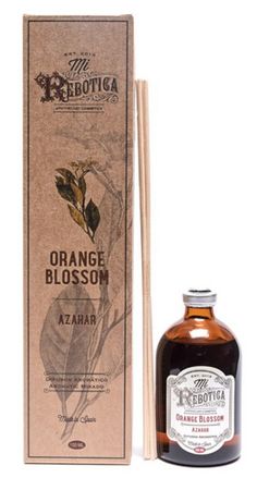 an orange blossom reed diffuser next to a cardboard box