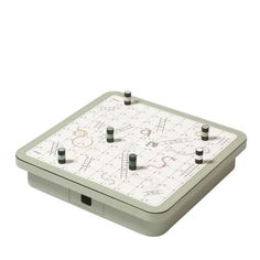 an old style game board with several different pieces on the top and two black pins sticking out of it