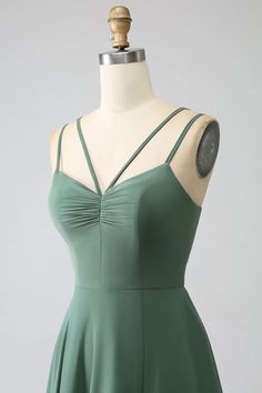 a green dress on a mannequin dummy