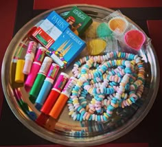 there are many different items in the tray on the table, including pens and pencils