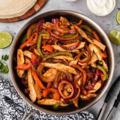 chicken fajita with peppers and onions in a skillet