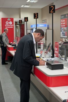 a man standing in front of a checkout counter