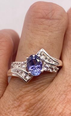 Rich and very bright blue iolite ring set with white sapphire accents.  925 Sterling silver  Size can be sized by my jeweler. His service charge is $20 All rings are shipped in a nice gift box.   Check out our over a THOUSAND great reviews Engraving is $4 per letter and is not always perfect depending on the piece. It can take a few days if the jeweler is busy. This is payable to Paypal Judithsltd@gmail.com Silver Tanzanite Diamond Ring With Accent Stones, Tanzanite Rings With Diamond Accents For Promise, Dazzling Tanzanite Promise Rings, Dazzling Tanzanite Rings For Gift, Silver Tanzanite Birthstone Ring, Silver Tanzanite Birthstone Ring As A Gift, Tanzanite Diamond Ring As A Gift, Silver Tanzanite Birthstone Ring With Accent Stones, Blue Amethyst Ring For Anniversary In Fine Jewelry Style