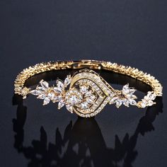 A classy bracelet in art deco vintage inspired style. Featuring intricately faceted cubic zirconia that catch the light from every angle, the bracelet is rhodium / rose gold / yellow gold plated for a flawless finish which perfectly enhances the intricate detailing and conveys a modern take on old elegance. Length: 7" (approx. 18cm); Width: 1" (approx. 2.6cm). Closure is a secure fold-over clasp. Weight: 14g.Choose between Silver, Rose Gold and Yellow Gold finishes. To make your choice select yo Glamorous Cubic Zirconia Crystal Bracelet Gift, Elegant Hand Set Crystal Bracelet For Party, Elegant Gold Crystal Bracelet With Diamonds, Classic Cubic Zirconia Bracelets For Party, Elegant Gold Diamond Crystal Bracelet, Elegant Cubic Zirconia Crystal Bracelet For Anniversary, Elegant Bracelet With Sparkling Stones For Anniversary, Rose Gold Cubic Zirconia Bracelet For Weddings, Glamorous Crystal Bracelets For Anniversary