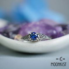 This Unique Victorian-style Sapphire Engagement Ring features a sparkling 5 mm (approximately .5 carat) round gemstone set in a dainty filigree setting.  This beautiful ring has a low-profile filigree mounting that protects the stone, but allows enough light in for it to sparkle brightly! This comfortable, snag-free setting is perfect for active people who are busy with their hands.  The mounting tapers gracefully from 6 mm at the widest point to 1.5 mm at the band. The band has been smoothed an Celestial Jewelry With Prong Setting As Gift, Heirloom Style Solitaire Sapphire Gift Ring, Heirloom Style Sapphire Solitaire Ring Gift, Blue Round Jewelry For Promise, Fine Jewelry Sapphire Ring With Filigree Design, Celestial Solitaire Ring As Gift, Celestial Solitaire Ring For Gift, Round Sapphire Filigree Jewelry, Sapphire Round Band Promise Jewelry