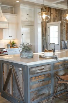 a kitchen with an island made out of wooden planks