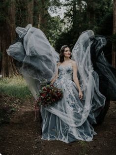 a woman in a wedding dress standing next to an animal