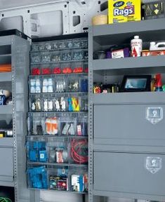 the inside of a storage compartment with many items and tools in it's bins