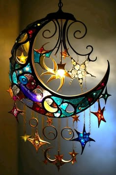 a multicolored moon and stars wind chime hanging from the ceiling