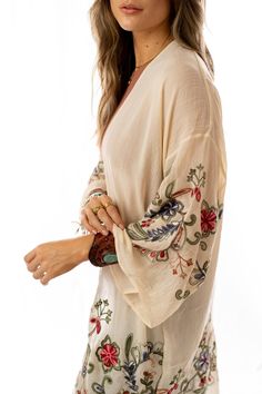 Nothing is more fun than a kimono covered in floral! This perfect layering piece features a sheer fabric in a longline silhouette with accents of crochet florals in multicolors along the hem and wide sleeves.Model is 5'8" and wearing one size.100% Polyester, Imported. OS sizing fits most* sizes US 0-18Length: 38 inBust Across: 25 inSleeve Length: 17 inSleeve Opening: 11 in Embroidered V-neck Kimono For Spring, Bohemian Sheer V-neck Cover-up, Spring Floral Embroidered Kimono With Kimono Sleeves, Spring Floral Embroidery Kimono With Kimono Sleeves, Bohemian Summer Cover-up For Layering, Spring Vacation Kimono With Floral Embroidery, Summer Floral Embroidery Kimono, Bohemian Floral Embroidered Open Front Kimono, Bohemian Open Front Kimono With Floral Embroidery