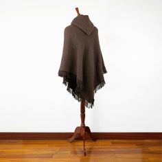 Introducing our exclusive unisex poncho, meticulously handcrafted from the finest llama wool yarn. This poncho is not just a garment; it's a blend of tradition and comfort. Its lightweight yet warm nature makes it an ideal choice for various settings. Key Features: Size: One Size, Approximately 48" Width x 43" Height / 122 cm Width x 110 cm Height, including fringe. Craftsmanship: Each poncho is a unique creation, handwoven by skilled indigenous artisans. Texture: soft to the touch, ensuring no Bohemian Hooded Brown Poncho, Oversized Brown Bohemian Poncho, Casual Brown One-size Poncho, Cozy Brown Alpaca Poncho, Poncho With Hood, Cozy Long Sleeve Alpaca Poncho, Christmas Board, Wool Yarn, Llama