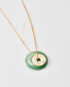 Jade Coin Necklace – Loren Stewart Gold Jade Necklace With Round Pendant, Gold Jade Round Pendant Necklace, Good Luck Coin Amulet Jewelry, Good Luck Coin Shaped Amulet Jewelry, Good Luck Coin-shaped Amulet Jewelry, Gold Jade Round Necklace, Traditional Jade Necklaces For Meditation, Traditional Jade Necklace For Meditation, Gift Amulet Style Coin Necklace With Adjustable Chain