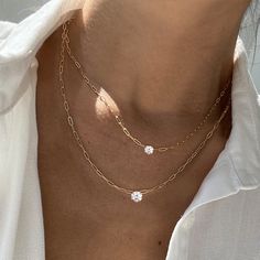 A twist on a classic, our Charo necklace features a choice of two different sized round diamonds secured in a 4 prong setting. A classic piece you will cherish for a lifetime. This necklace can be dressed up or down, layered with our Herringbone Chain Necklace , or worn by itself. – Made in 18k solid gold with a high-quality ethically sourced diamond. – Handpicked G-H/SI Round Brilliant Diamond, carat weight 0.50 – Choice of adjustable chain length, 16 and 18 inches. – Handcrafted just for you i Formal Double Strand Diamond Necklace, Timeless Cubic Zirconia Necklace With Prong Setting, Elegant Chain Necklace With Brilliant Cut, Timeless Diamond White Necklace With Prong Setting, Elegant Double Strand Diamond Necklaces, Elegant Double Strand Diamond Necklace, Delicate Cubic Zirconia Necklace With Prong Setting, Timeless Solitaire Necklace With Clavicle Chain, Timeless Solitaire Necklace With Clavicle Chain As A Gift