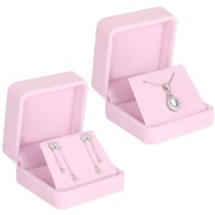 two pink jewelry boxes with necklaces and earrings