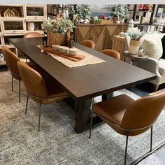 a dining room table with brown chairs around it