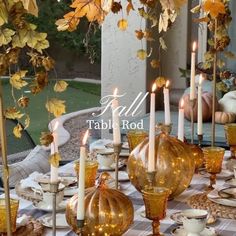 the table is set with candles, dishes and other things to eat for thanksgiving dinner