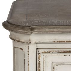 an old white dresser with wood top and drawers on the bottom, in front of a white background