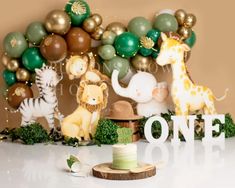 an image of a birthday cake with animals and balloons on the wall in the background