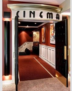 an open door leading to a room with red carpet and white trim on the walls