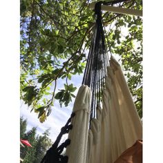 an outdoor hammock hanging from a tree