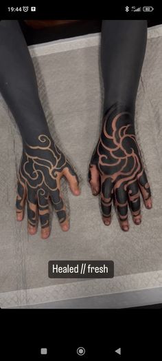 two hands that have tattoos on them