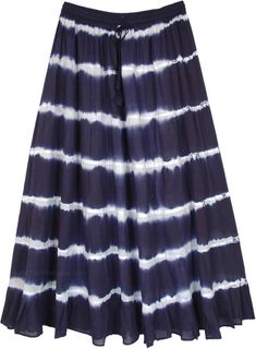 A light and breezy feminine long cotton summer skirt is exactly what you need for the season! With its harmonious balance of cool tones of ink blue, it is sure to bring glow to your face.  The skirt is in tie-dye pattern and has an elastic waist with drawstring for ease of comfort. #tlb #TieredSkirt #MaxiSkirt #vacationclothing #beachwrap #TieDye #CottonMaxiSkirt #TieDyeSkirt #SummerSkirt #BeachSkirt Flowy Cotton Beach Skirt, Flowy Cotton Summer Skirt, Indigo Bohemian Bottoms For Summer, Bohemian Indigo Bottoms For Summer, Cotton Tie Dye Skirt For Summer, Tie Dye Long Skirt For Summer, Tie Dye Tiered Skirt For Summer, Casual Tie Dye Skirt For The Beach, Casual Indigo Skirt For Summer