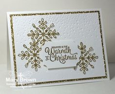 a white card with gold glitter snowflakes and the words happy new year written on it