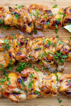 chicken skewers with cilantro and parsley on a cutting board