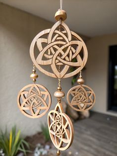 Discover the beauty of this wooden wind chime featuring intricate Celtic knots and charming beads! Perfect for adding a serene touch to any outdoor space. What do you think about this piece?  Share your thoughts and tag a friend who loves woodwork! . #woodworking #wood #handmade #woodworker #woodwork #diy #design #smallbusiness #interiordesign #woodart #art #homedecor #furniture #wooddesign #carpentry #woodcraft Celtic Woodwork, Wooden Wind Chimes, Woodworking Accessories, Woodwork Diy, Diy Woodworking Projects, Chip Carving, Wood Designs, Celtic Knots, Woodworking Wood