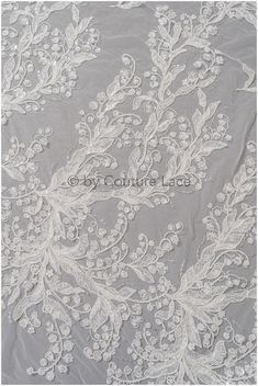 white lace fabric with flowers and leaves on grey background, suitable for wedding dress or bridal