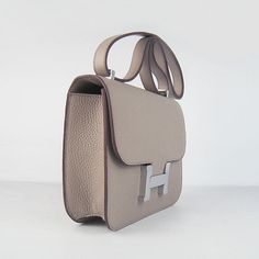 The material is a beautiful leather which is very chic and durable.The color on this bag is complemented with palladium (Silver-toned) or goldtone hardware.This is THE bag for the Hermes connoisseur.The bag is opened and closed using the magnetic closure in the front - letter 'H'.The interior is lined with soft evercalf leather and features 2 compartments.Each compartment has a side pocket. The exterior also features a side pocket.This is a VERY VERY understated bag. Definitely classic and can be worn the whole year long.It will come with 2 sleeper bags, one for bag one for mirror.MARKINGS: All the hardware are marked 'Hermes' and it is also stamped 'Hermes, Paris, Made in France' under the front flap. It is also marked with a craftsman's ID and year Hermes Constance, Letter H, Hermes Paris, Louis Vuitton Shoes, Dior Shoes, Vuitton Bag, Side Pocket, Magnetic Closure, Dior Bag