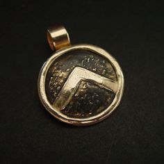 "This Spartan Shield necklace is hand sculpted, domed and beaten up to look like it has been on a battlefield. The letter lambda (Λ), standing for Laconia (administrative capital of Sparta) or Lacedaemon (ancient name for the city of Sparta), which was painted on the Spartans' shields, was first adopted in the 420s BC, and quickly became a widely known Spartan symbol. Military families passed on their shields to each generation as family heirlooms. - Hand sculpted pendant - Solid yellow bronze a Ancient Style Yellow Gold Brass Jewelry, Collectible Etched Amulet Jewelry, Antique Gold Soldered Pendant Jewelry, Antique Gold Soldered Round Pendant Jewelry, Antique Gold Jewelry With Soldered Round Pendant, Collectible Etched Bronze Jewelry, Ancient Style Bronze Coin Pendant Jewelry, Ancient Bronze Coin Jewelry, Ancient Bronze Coin Pendant Jewelry