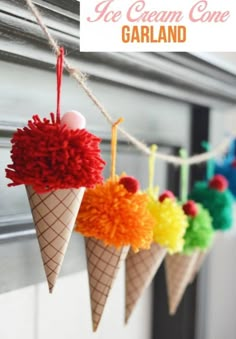 an ice cream cone garland with pom - poms hanging from it