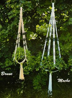 three different types of macrame hanging from trees in front of green leaves and bushes