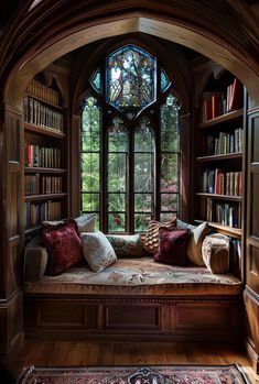 a window seat with pillows on it in front of a bookcase filled with books