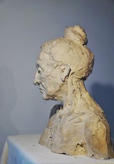 a sculpture of a man's head on a table