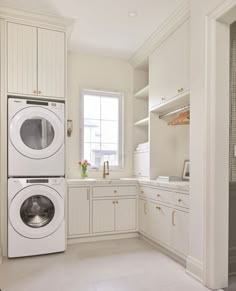 a washer and dryer in a white kitchen