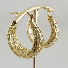 Step into the world of elegance and style with our stunning Gold Plated Filigree Hoop Earrings. Designed to make a statement, these earrings add a touch of glamour to any ensemble. Get ready to turn heads and feel fabulous!Inner diameter: 18mm - 11/16 in.Outer Diameter: 25mm - 1 in.Width at the bottom: 9mm - 3/8 in. Filigree Hoop Earrings, Gold Plate, Hoop Earrings, Plating, Floral, Gold