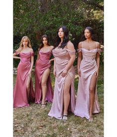 four women in long dresses standing next to each other with one woman's leg high