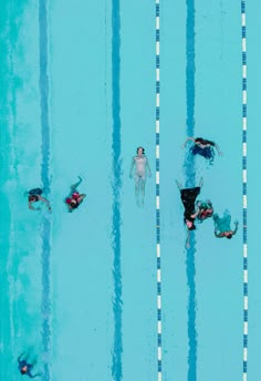 people are swimming in the pool with their backs turned to the side as they swim