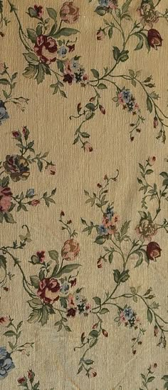 an old rug with flowers and leaves on it