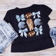 a women's t - shirt with an image of a tiger and footballs on it